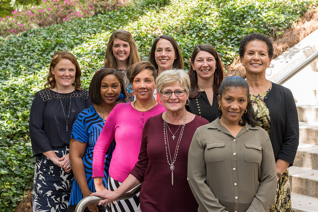 Group portrait of nine women who are members of the Event Coordinators' Network