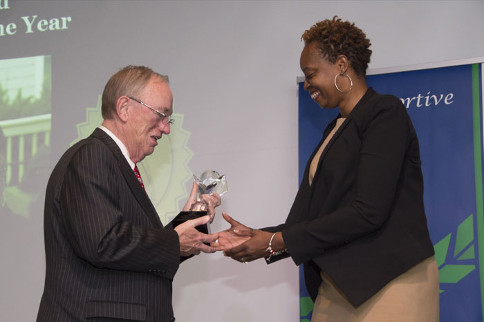 Kim Harrington receiving her award and congratulations from USG Chancellor Hank Huckaby